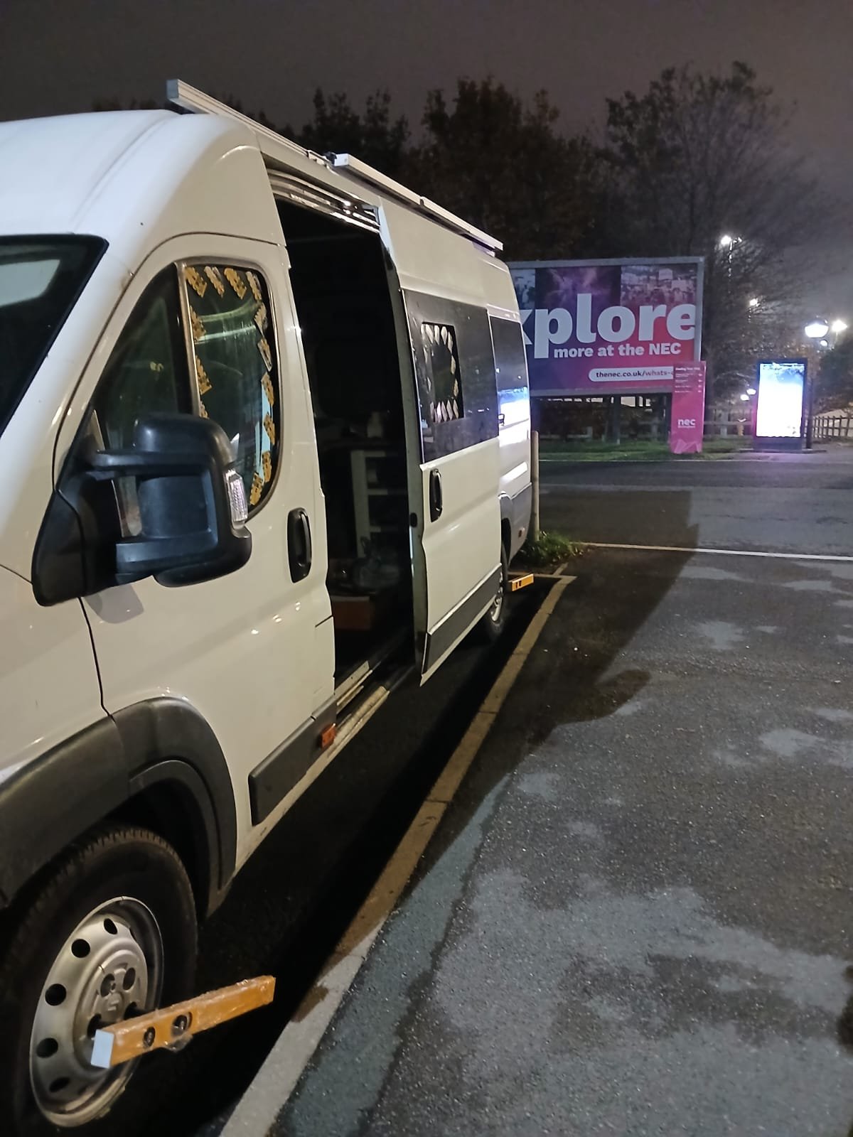 Camper conversion secured with the KLUNK wheel lock at night